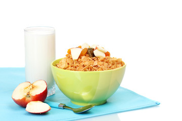 tasty cornflakes in bowl with dried fruits, glass of milk and