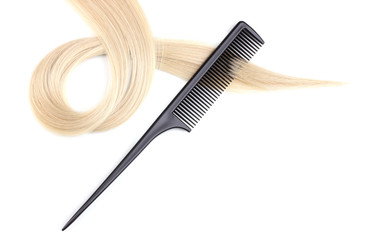 Shiny blond hair and comb isolated on white