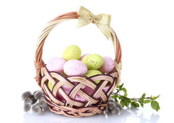 basket with Easter eggs and pussy-willow twigs isolated on white