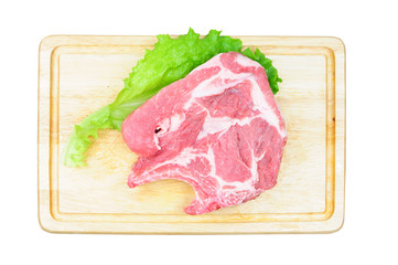 Raw pork meat on wooden board