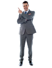 Businessman in suit pointing at copyspace