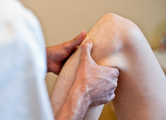 Healing hands - Osteopathic treatment on patient's knee