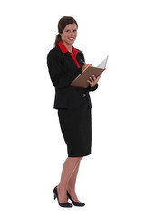 Businesswoman writing in book