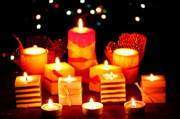 Wonderful candles on wooden table on bright background
