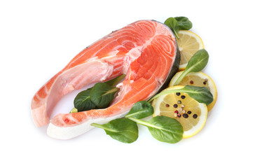 Red fish with lemon, green leaves and pepper isolated on white.