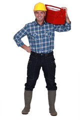 Man carrying tool box on shoulders