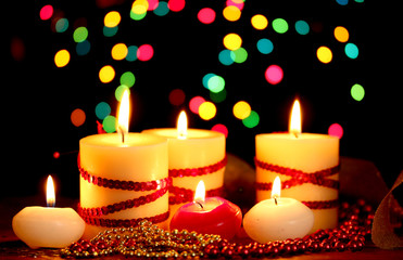 Beautiful candles and decor on wooden table on bright background