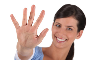 Obraz na płótnie Canvas Brunette holding hand in stop gesture