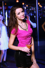 Young woman having fun at nightclub disco