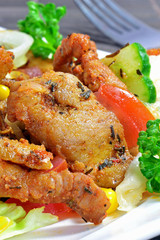 A meal of grilled meat and mixed salad on a plate