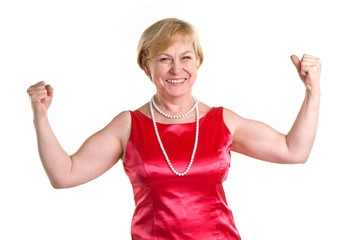 Portrait of fit senior woman flexing her biceps against white