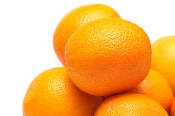 Many ripe oranges closeup isolated on white