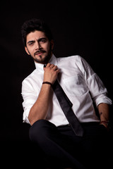 Fototapeta premium young successful business man isolated on black background