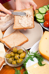 Spreading tuna spread on sandwich