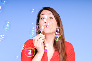 Young woman blowing bubbles