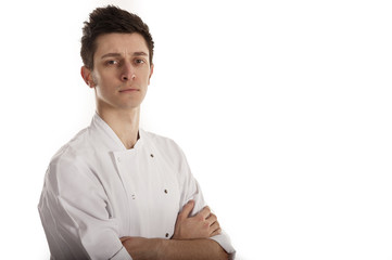 Chef wearing white jacket with folded arms