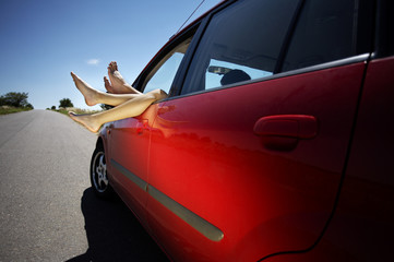Legs hanging out of the car