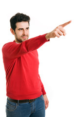 happy young man pointing at something interesting over white bac