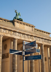 Obraz premium Direction Sign by Brandenburg Gate