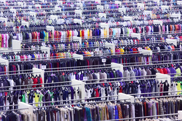 Large clothing store, many rows with hangers, variety of sizes