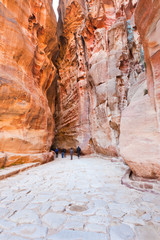 antique roman paved road in Siq passage in city Petra,