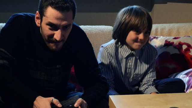 Father and son playing with videogames