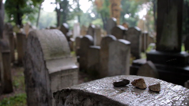 Rain dripping on stones and Jewish grave, close-up