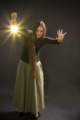 The girl goes with a lantern and shines a way