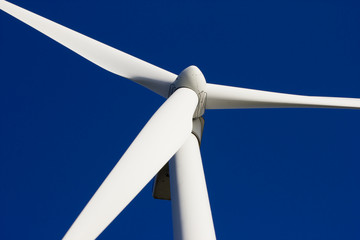 A wind-turbine against a clear blue sky