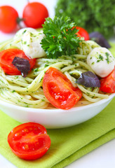 spaghetti with pesto sauce,cherry tomato and cheese