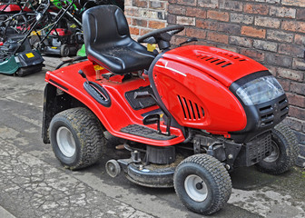 A bright red ride on lawnmower 
