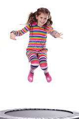 Young girl jumping on a trampoline