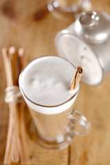 coffee latte with cinnamon sticks, focus on stiks end, , shallow