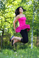 Young woman jumping in the garden