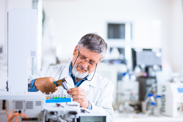 senior male researcher carrying out scientific research in a lab