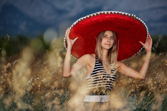 Young Girl With A Sombrero In The Early Evening