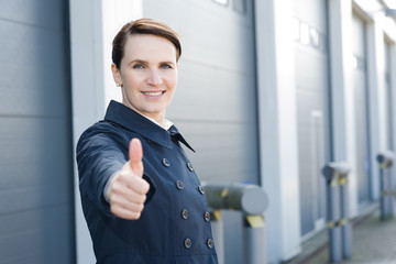 Business woman in front of warehouse
