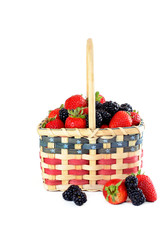Patriotic basket of fresh strawberries and blackberries isolated on white with copy space.