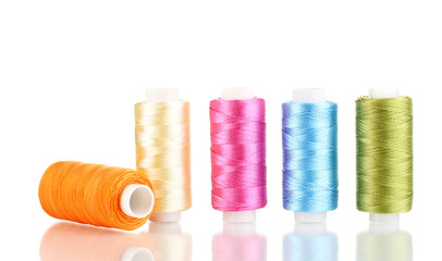 Many spools of thread isolated on white