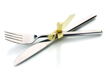 Silver fork and knife tied with ribbon isolated on white