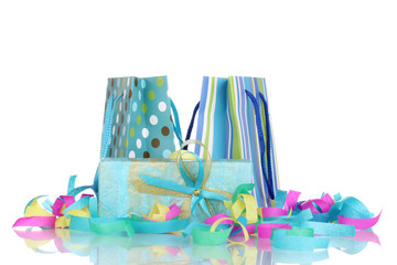 Colorful gift bags and gifts  with serpentine isolated on white