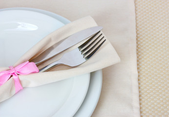 Table setting with fork, knife, plates, and napkin