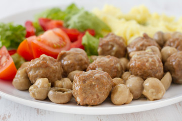 meatballs with mushrooms, mashed potato and salad
