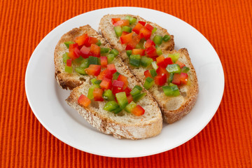 toasts with cut pepper on the plate