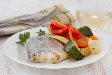 boiled swordfish with vegetables on the plate