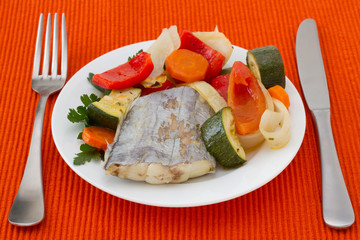 boiled swordfish with vegetables on the plate