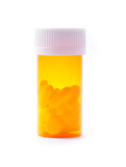 Pill bottle with pills on white background