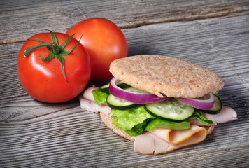 Turkey sandwich on whole wheat with onion, cucumber, lettuce and