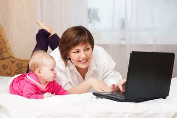 mother and baby with notebook