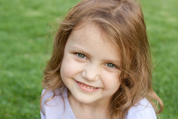 portrait of a smiling child outdoors